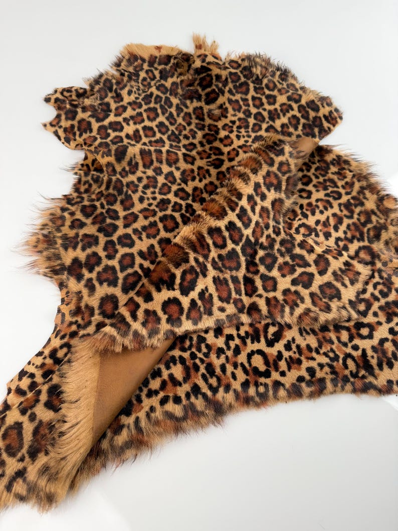 May include: A brown and black leopard print fur rug with a soft, fluffy texture.