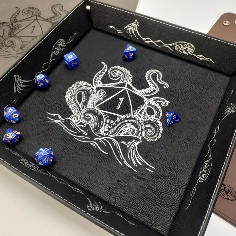 Image of D20 ship sinking from Kraken pulling it into the ocean on a large leather dice tray.