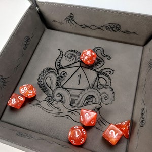 Gray dice tray with orange D&D dice