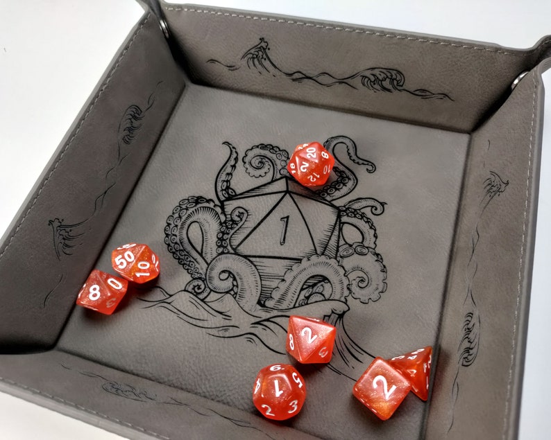 Gray dice tray with orange D&D dice