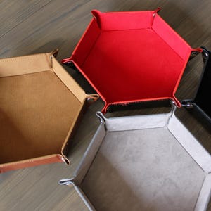 Assortment of colored dice trays: brown, red, grey, and black