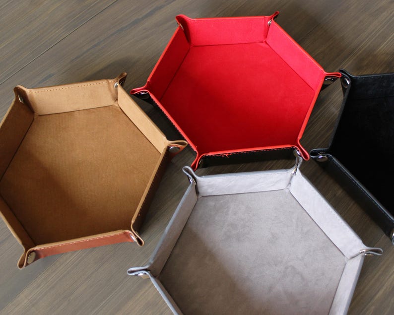 Assortment of colored dice trays: brown, red, grey, and black