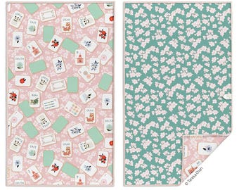 May include: Reversible play mat with a pink side featuring playing cards and floral accents, and a teal side with a white floral pattern. The mat is designed for games and activities.