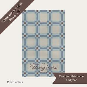 May include: A blue, beige, and brown patterned microfiber towel. The towel has a grid design with the text "The Ellingtons EST 2026" and is 40x64 cm. The text "Waffle-knit microfiber dries quickly!" is also present. Customizable name and year.