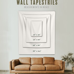 May include: Four white wall tapestries of different sizes, displayed on a wall with a brown leather couch in front of them. The tapestries are labeled with their measurements in inches: 26" x 36", 50" x 60", 68" x 80", and 88" x 104".