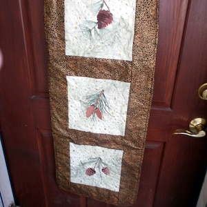Embroidered Pinecone Quilted Door Hanging: Winter Apartment Decor