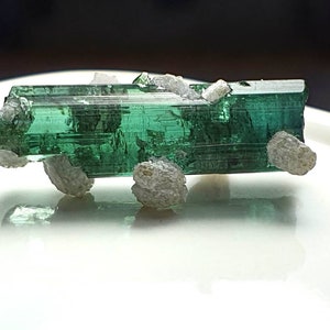 Bluish green tourmaline specimen with lapadolite