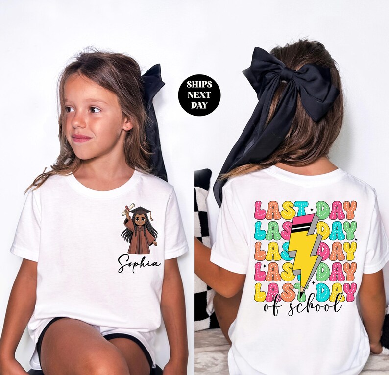 A young girl wearing a white t-shirt with a graphic design and text printed on it.