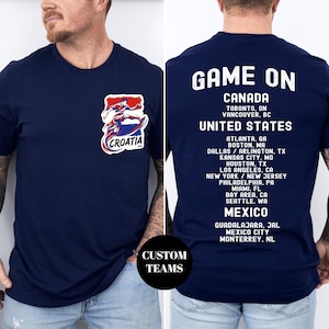 A man wearing a navy blue t-shirt with a graphic of a hockey player and text on the back, along with a list of locations in the United States and Mexico.