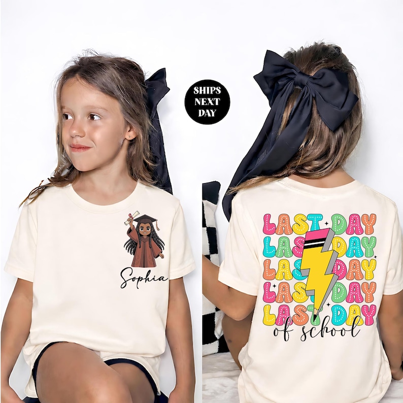 A young girl wearing a white t-shirt with a graphic design and text on the back.