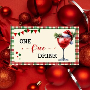 Può includere: Immagine festiva natalizia con sfondo rosso, decorazioni rosse e nastri argentati. Una scheda rettangolare con le parole "ONE free DRINK" e un'illustrazione di cocktail è il punto focale. La scheda ha un bordo a scacchi e piccoli accenti verdi e rossi.