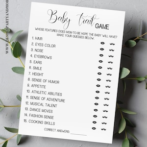 May include: A printable baby shower game with the title "Baby Trait Game". The game asks guests to guess which features the new baby will have, such as hair color, eye color, and sense of humor. The game includes a list of 15 traits and a space for guests to write down their answers.
