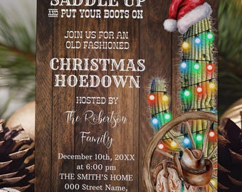 May include: A rectangular Christmas party invitation card with a dark wood grain background. It features a cactus wearing a Santa hat, wrapped in colorful string lights, next to a wooden wagon wheel and a pair of brown leather cowboy boots.