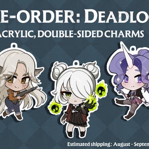 May include: Three 2.5-inch acrylic double-sided charms featuring chibi-style characters. The text reads PRE-ORDER: DEADLOCK and 2.5" ACRYLIC, DOUBLE-SIDED CHARMS. The characters include a wolf-eared figure, a character with green skull magic, and a unicorn.