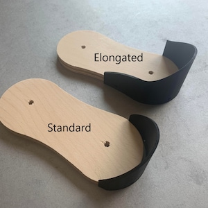 May include: Two wooden shoe forms, one labeled "Standard" and the other labeled "Elongated". Both forms have a black leather heel cup.