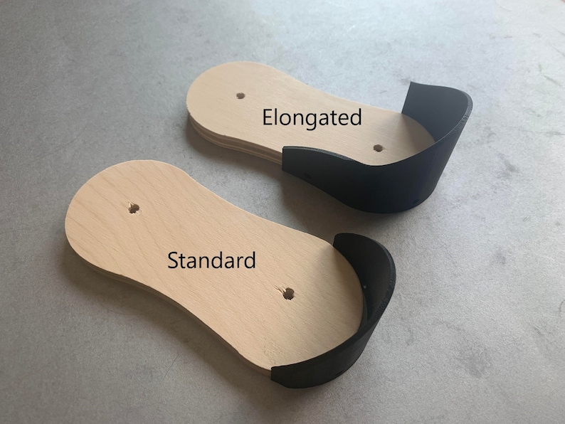 May include: Two wooden shoe forms, one labeled "Standard" and the other labeled "Elongated". Both forms have a black leather heel cup.