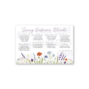 May include: A white card with the text "Spring Diffuser Blends" in purple script. The card lists essential oil blend recipes like "Fresh Bouquet" and "Sweetly Spring." Floral illustrations border the bottom.