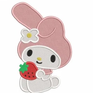 May include: A pink and white embroidered patch of a cartoon bunny rabbit holding a red strawberry. The bunny has a white flower on its head and is wearing a pink dress.