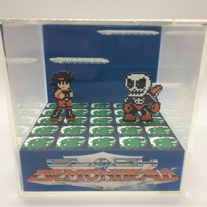 May include: A pixelated diorama featuring two characters in a video game scene. One character is a person in orange and black, facing a skeletal figure. The background is blue with a pixelated cloud. The base reads "SLASH DEMONHEAD".