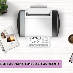 A desktop scene showing a printer printing the Earth Day coloring page. Includes a notebook with photos, coffee mug, smartphone, and text at bottom saying "REPRINT AS MANY TIMES AS YOU WANT!" on a purple banner.