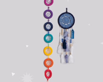 May include: Two dream catchers are displayed against a light gray background. One is a vertical string of colorful rings, and the other is a blue dream catcher with feathers and beads. The rings are in rainbow colors.