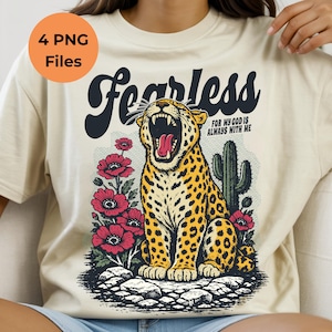 May include: Cream-coloured t-shirt with a graphic of a roaring leopard, red flowers, and a cactus. The word "Fearless" is above the leopard, with the text "FOR MY GOD IS ALWAYS WITH ME" below.