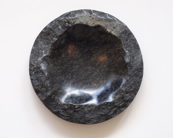Plate made of black natural stone.