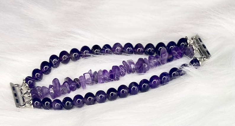May include: A purple amethyst gemstone Apple Watch band with two rows of beads. The top row is made of small, irregular shaped beads and the bottom row is made of round beads.