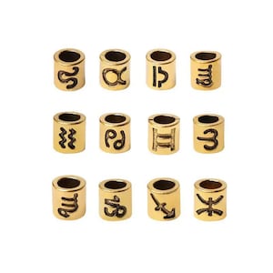 May include: Twelve gold-colored metal beads with different zodiac symbols engraved on them. The symbols include Aquarius, Aries, Cancer, Capricorn, Gemini, Leo, Libra, Pisces, Sagittarius, Scorpio, Taurus, and Virgo.