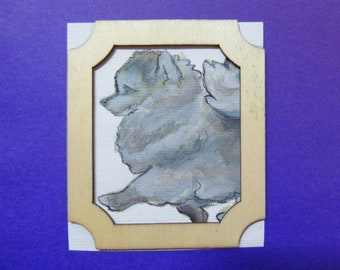 Kleines Bild eines Spitzhundes mit Rahmen