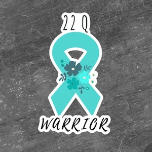 May include: Teal blue ribbon with floral design and the text "22Q Warrior".