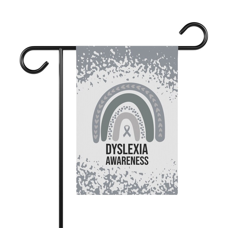 May include: A gray and white garden flag with a rainbow design and the text "Dyslexia Awareness". The rainbow is made up of three arches with a gray ribbon in the center.