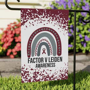 May include: A white garden flag with a maroon and gray rainbow design. The rainbow has a maroon ribbon in the center. The text "FACTOR V LEIDEN AWARENESS" is printed below the rainbow.