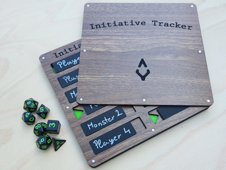 May include: Wooden initiative tracker with the text "Initiative Tracker" and a black symbol. Includes black and green dice and black labels for players and monsters. The tracker is made of wood.