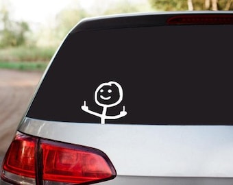 May include: A white stick figure with a smiling face is giving the middle finger with both hands. The stick figure is on a black background on the back window of a silver car.