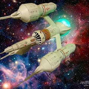 May include: A model spaceship in white and tan, set against a backdrop of a colourful galaxy. The spaceship has multiple sections, including a central body, wings, and pointed extensions. The image includes the text "redflare model studios."