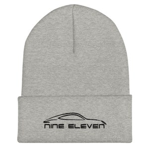 May include: Gray beanie with a black outline of a car and the text "NINE ELEVEN" embroidered on the front.