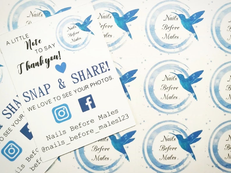 May include: White cards and stickers featuring blue hummingbird designs and text. The cards read "A little note to say Thank you!" and "Snap & Share!" with social media icons. The stickers display the text "Nails Before Males".