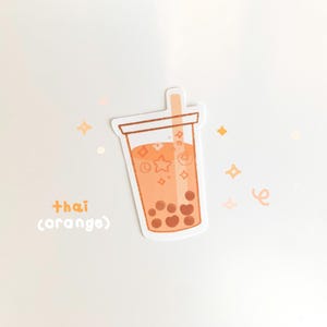May include: A sticker of a cartoon orange thai tea with boba pearls and a straw. The sticker has a white background with a light orange and yellow color scheme. The text "thai (orange)" is written below the sticker.