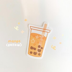 May include: A sticker of a yellow mango boba tea with a straw and white stars and swirls inside. The text "mango (yellow)" is below the boba tea.