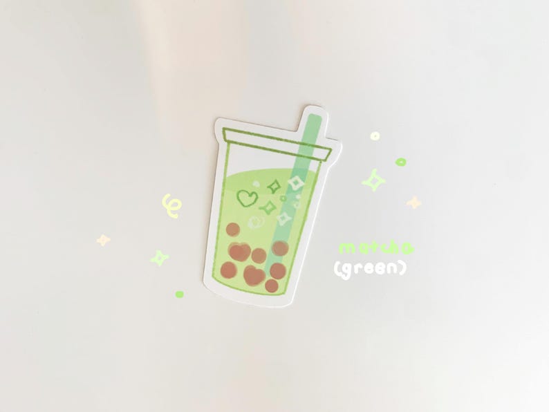 May include: Green bubble tea sticker with a green straw and brown boba pearls. The sticker has a white background and the text "matcha (green)" is written below the bubble tea.