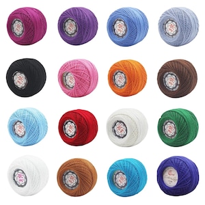 May include: A collection of sixteen round balls of cotton yarn in various solid colors including magenta, purple, blue, light blue, black, pink, orange, brown, red, white, green, tan, turquoise, and dark blue, each with a central label.