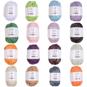 May include: Sixteen individual skeins of fabric yarn arranged in a four-by-four grid. Each skein features a white paper label with black text and Chinese characters. The yarn colors include white, lime green, light blue, lavender, dark green, pink, lilac, dark brown, orange, purple, bronze, light gray, beige, tan, teal, and bright orange.