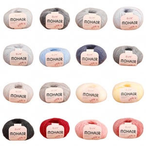 May include: A selection of mohair yarn balls in shades of grey, blue, and pink. Each ball features a label with the text "QJH MOHAIR". The yarn has a soft, fluffy texture, ideal for knitting or crochet crafts.