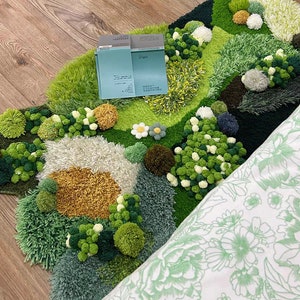 May include: A green, white, and yellow rug with a textured, fluffy surface. The rug is shaped like a cloud and has a variety of different textures and colors. The rug is made of yarn and has a variety of different shapes and sizes. The rug is perfect for adding a touch of whimsy to any room.