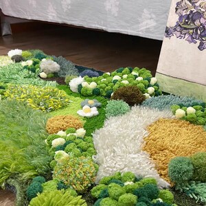 May include: A green, yellow, and white rug with a fluffy texture. The rug is made of yarn and has a variety of different shapes and sizes. The rug is perfect for adding a touch of whimsy to any room.