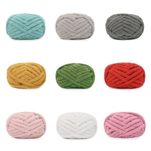 May include: A collection of nine skeins of chunky chenille yarn arranged in a grid. The colors include teal, light gray, dark gray, mustard yellow, olive green, bright red, light pink, white, and dusty rose, all featuring a soft texture.