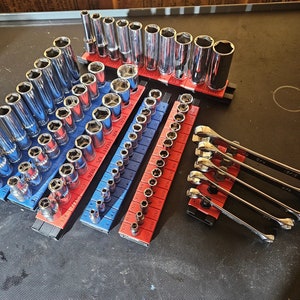 May include: A set of chrome socket wrenches and ratcheting wrenches organized in a blue and red tool holder. The wrenches are arranged in size order, with the smallest wrenches at the top and the largest wrenches at the bottom.