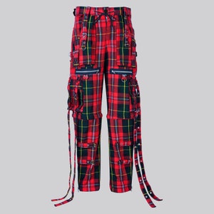 May include: Red and black plaid cargo pants with multiple straps and buckles. The pants have a drawstring waist and multiple pockets.