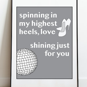 May include: A gray background with white text that reads "spinning in my highest heels, love shining just for you". A white high heel shoe and a black and white disco ball are also pictured.